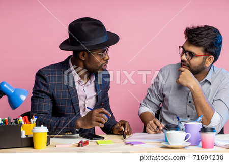 Two businessmen speaking and working at the office 71694230