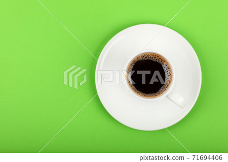 Full white espresso coffee cup over green 71694406
