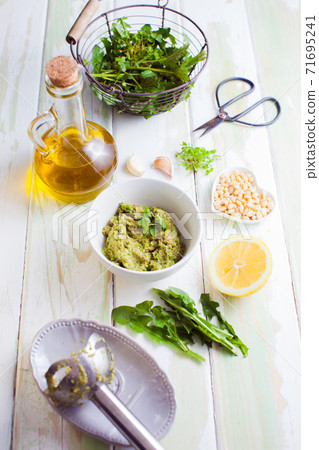 fresh wild herbs pesto ingredients on wooden table fresh wild herbs pesto ingredients on wooden table 71695241