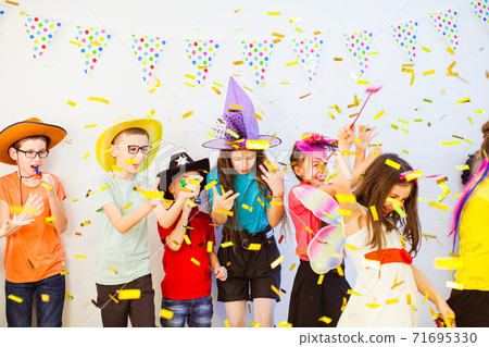 Kid's Birthday party with party horns and confetti 71695330