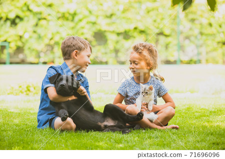 Cheerful brother and sister happily chatting in park Cheerful brother and sister happily chatting in park 71696096