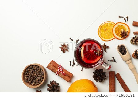 Cup of mulled wine and ingredients on white background 71696181