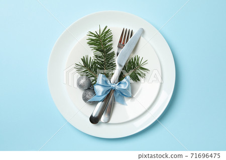Plates with New year cutlery on blue background 71696475