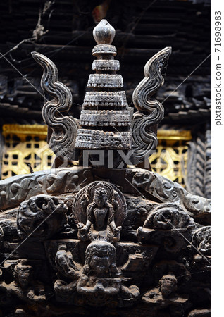 Carved wooden details on a Nepalese temple door 71698983
