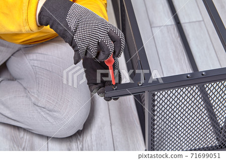 Mounting of furniture with metal frame by assembler using screwdriver. 71699051