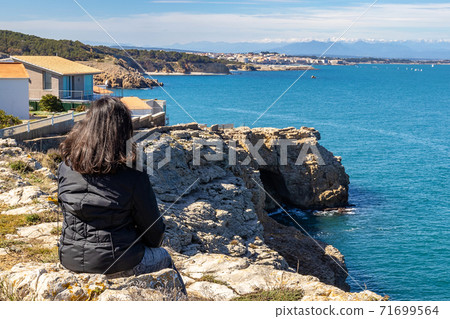 Woman looking at Costa Brava landscape from Spain Woman looking at Costa Brava landscape from Spain 71699564