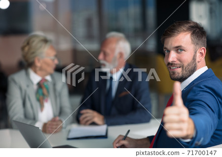 Positive aged couple consulting with insurance agent 71700147