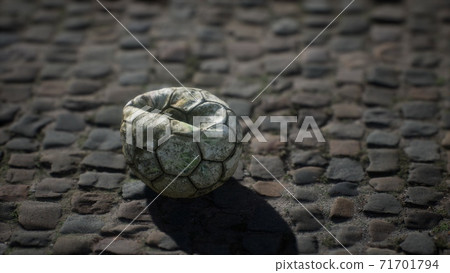Old soccer ball in the pavement yard 71701794