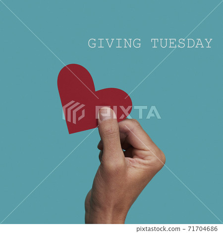 person giving a heart and text giving tuesday 71704686