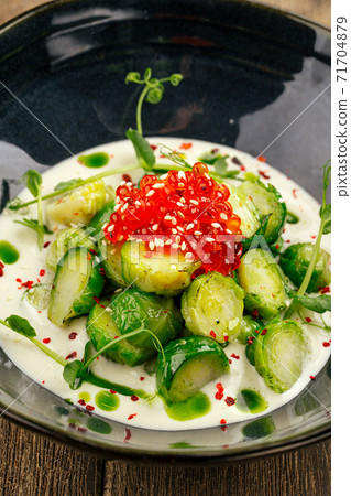 Brussels sprouts with caviar in a black bowl Brussels sprouts with caviar in a black bowl 71704879