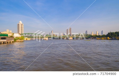 Memorial Bridge, and Phra Pok Klao Bridge with buildings and Chao Phraya River at noon. Urban city, Downtown Bangkok, Thailand. 71704900