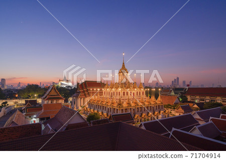 Loha Prasat Wat Ratchanatda and Golden Mountain pagoda, a buddhist temple or Wat Saket with skyscraper buildings in Bangkok Downtown, urban city, Thailand. Thai Landmark. Architecture. 71704914