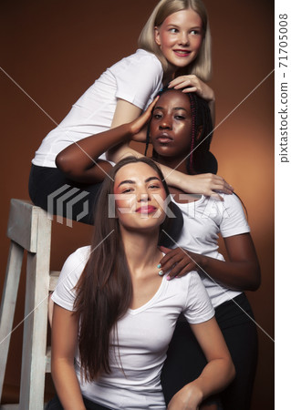 young pretty asian, caucasian, afro woman posing cheerful together on brown background, lifestyle diverse nationality people concept young pretty asian, caucasian, afro woman posing cheerful together on brown background, lifestyle diverse nationality people concept 71705008