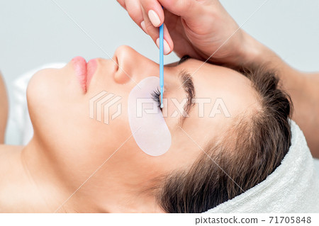 Hand wipes eye by cotton bud. Hand wipes eye by cotton bud. 71705848