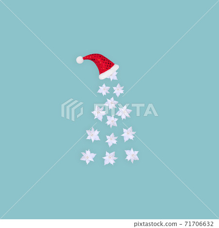 Contemporary collage. 3D illustration. Abstract Christmas background with a white tree made of flowers and in a red cap on a blue background. 71706632