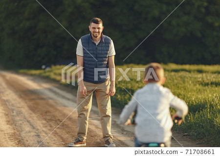 Cute family playing in a autumn field Cute family playing in a autumn field 71708661