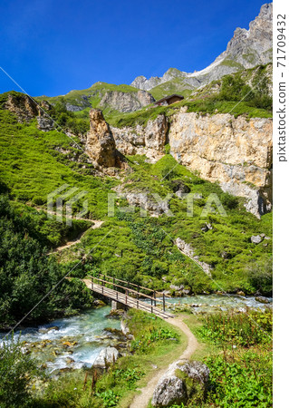 Mountain river and wood bridge in Vanoise national Park valley, French alps 71709432