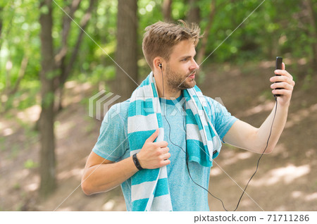 Sweaty selfie. Handsome sportsman take selfie with smartphone. Hand selfie Sweaty selfie. Handsome sportsman take selfie with smartphone. Hand selfie 71711286