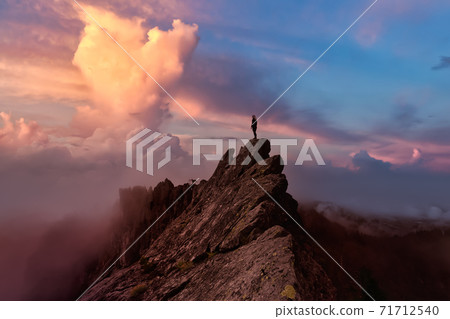 Adventurous Girl on top of a Mountain Peak Adventurous Girl on top of a Mountain Peak 71712540