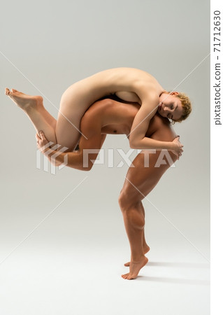 Naked couple hugging together on gray background 71712630