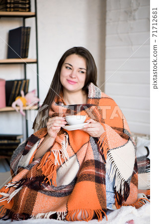 Pregnant woman drinking tea in bed at home. Pregnant woman drinking tea in bed at home. 71712681