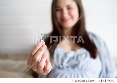 Pregnant woman looking at baby ultrasound scan. Pregnant woman looking at baby ultrasound scan. 71712689