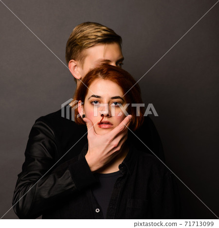 Desparate young woman with aggressive man in studio, domestic violence conception Desparate young woman with aggressive man in studio, domestic violence conception 71713099