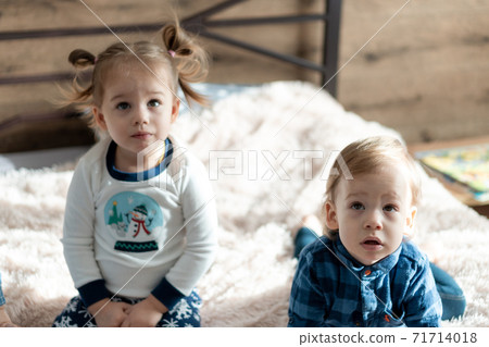soft focus friendship, childhood, technology concepts - two minors children siblings watch cartoons on phone, smartphone indoor. Infant baby kids brother, sister speak by video conference on gadget 71714018