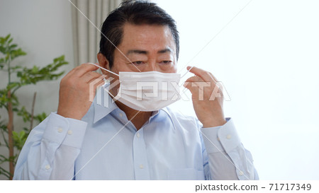 Middle-aged man wearing a mask 71717349