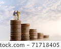 Elderly people sitting on coins stack. 71718405
