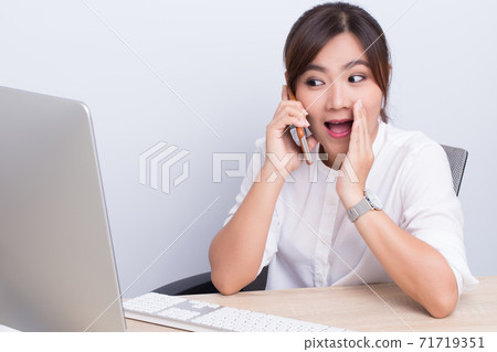 Asian woman telling secret in the office Asian woman telling secret in the office 71719351