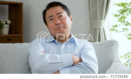 Middle-aged man thinking frowning Middle-aged man thinking frowning 71719396