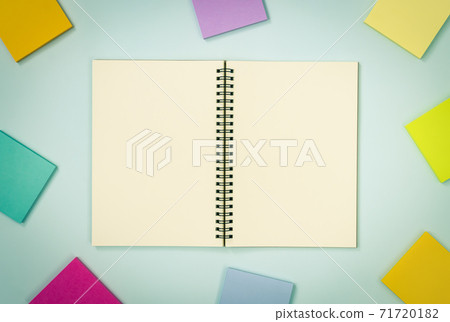 Top Table Spiral Notebook and Stick Note on Pastel Minimalist Background in Vintage Tone 71720182