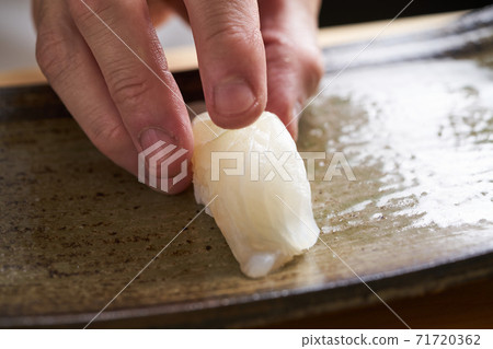 Itamae holding flatfish sushi Itamae holding flatfish sushi 71720362