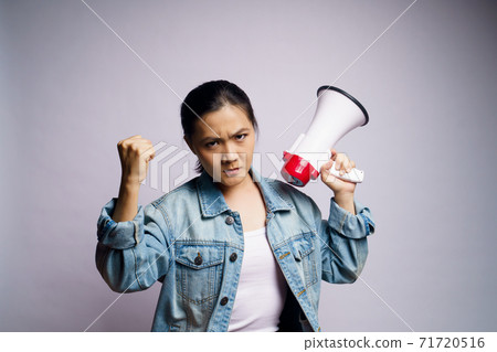 Asian woman shouting with megaphone isolated over white background. 71720516
