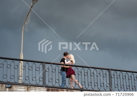 Beautiful loving each other couple is standing on the bridge Beautiful loving each other couple is standing on the bridge 71720906