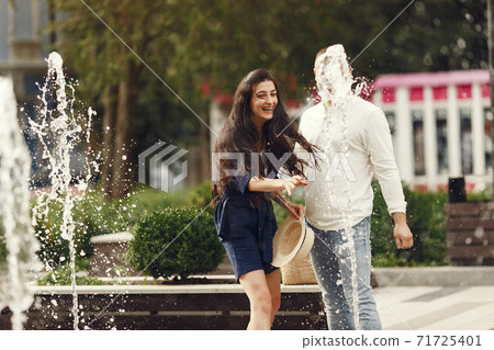 Beautiful couple spend time in a summer city Beautiful couple spend time in a summer city 71725401