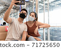 Young couple man and woman wearing face mask selfie by smartphone while waiting to on board in the airport. 71725650