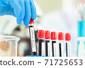 scientist in laboratory with test tubes 71725653