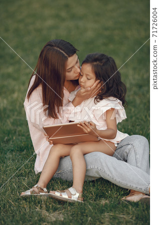 Elegant mother with daughter in a summer park 71726004