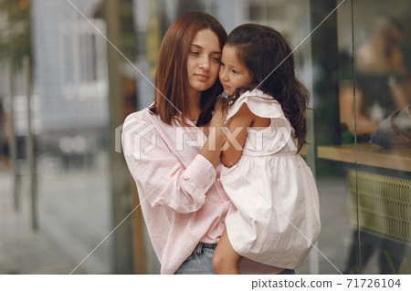 Elegant mother with daughter in a summer park Elegant mother with daughter in a summer park 71726104