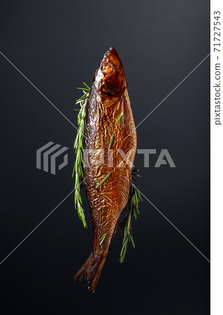 Smocked herring on a black background. Smocked herring on a black background. 71727543