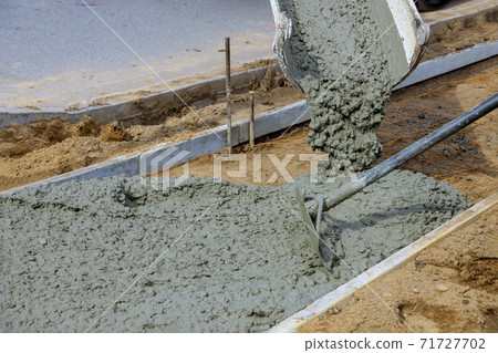 Cement of sidewalk a new building under construction Cement of sidewalk a new building under construction 71727702