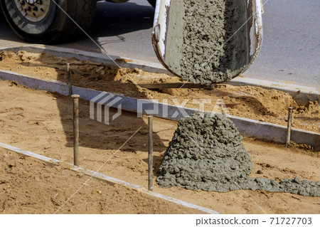 Pouring cement during concrete sidewalk Pouring cement during concrete sidewalk 71727703