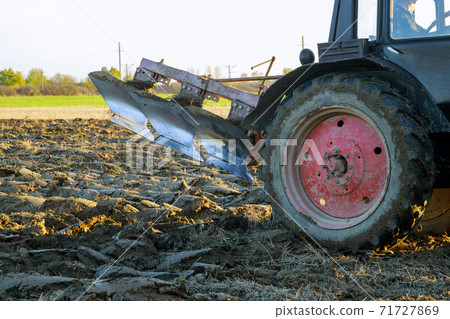 Plowed field tractor in soil on open countryside nature. Plowed field tractor in soil on open countryside nature. 71727869