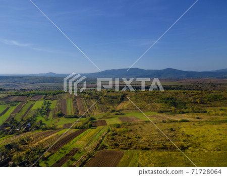 Aerial view of green farmland of the countryside cultivated field from above Aerial view of green farmland of the countryside cultivated field from above 71728064