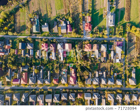 Beautiful village house in a small village in top aerial view small green village from above with fields Beautiful village house in a small village in top aerial view small green village from above with fields 71728094