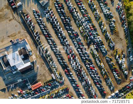 Aerial view of auto auction many used car lot parked distributed in a parking. Aerial view of auto auction many used car lot parked distributed in a parking. 71728571