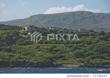 People enjoying living in beautiful landscape full of rock formations along the irish coastline near Killybegs, County Donegal in Ireland People enjoying living in beautiful landscape full of rock formations along the irish coastline near Killybegs, County Donegal in Ireland 71730247