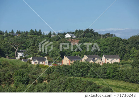 People enjoying living in beautiful landscape full of rock formations along the irish coastline near Killybegs, County Donegal in Ireland People enjoying living in beautiful landscape full of rock formations along the irish coastline near Killybegs, County Donegal in Ireland 71730248